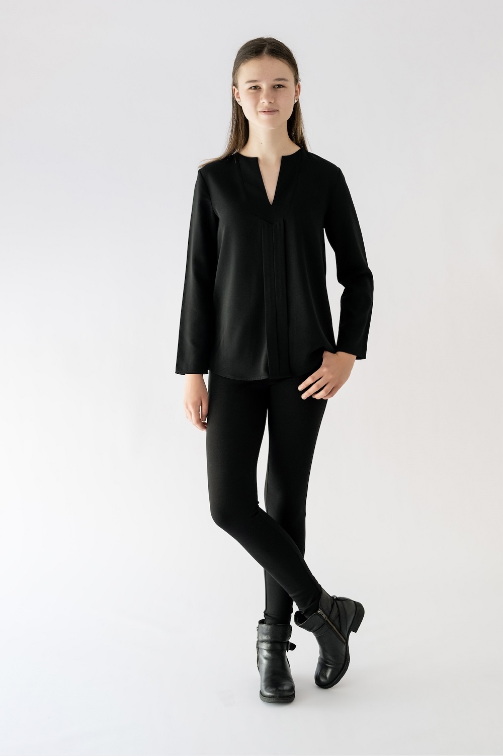 girl standing wearing black blouse and black pant