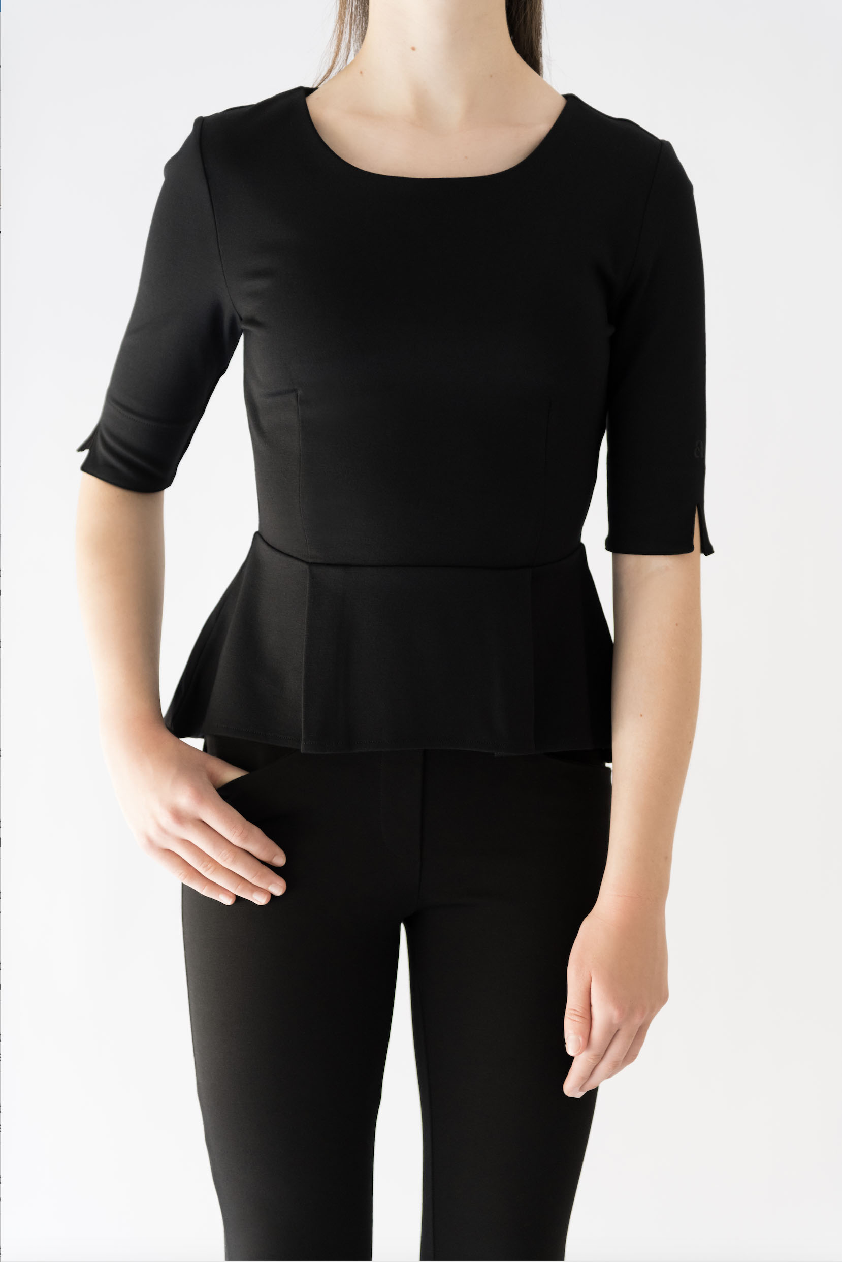 girl wearing black peplum top and black pant