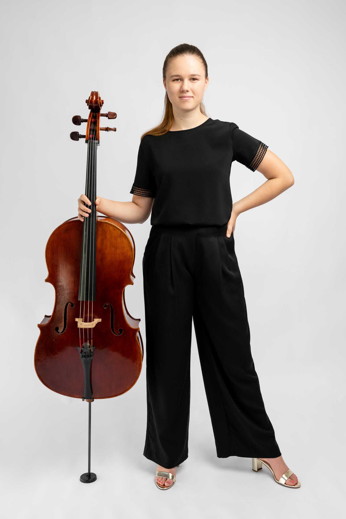 girl in black clothes holding cello