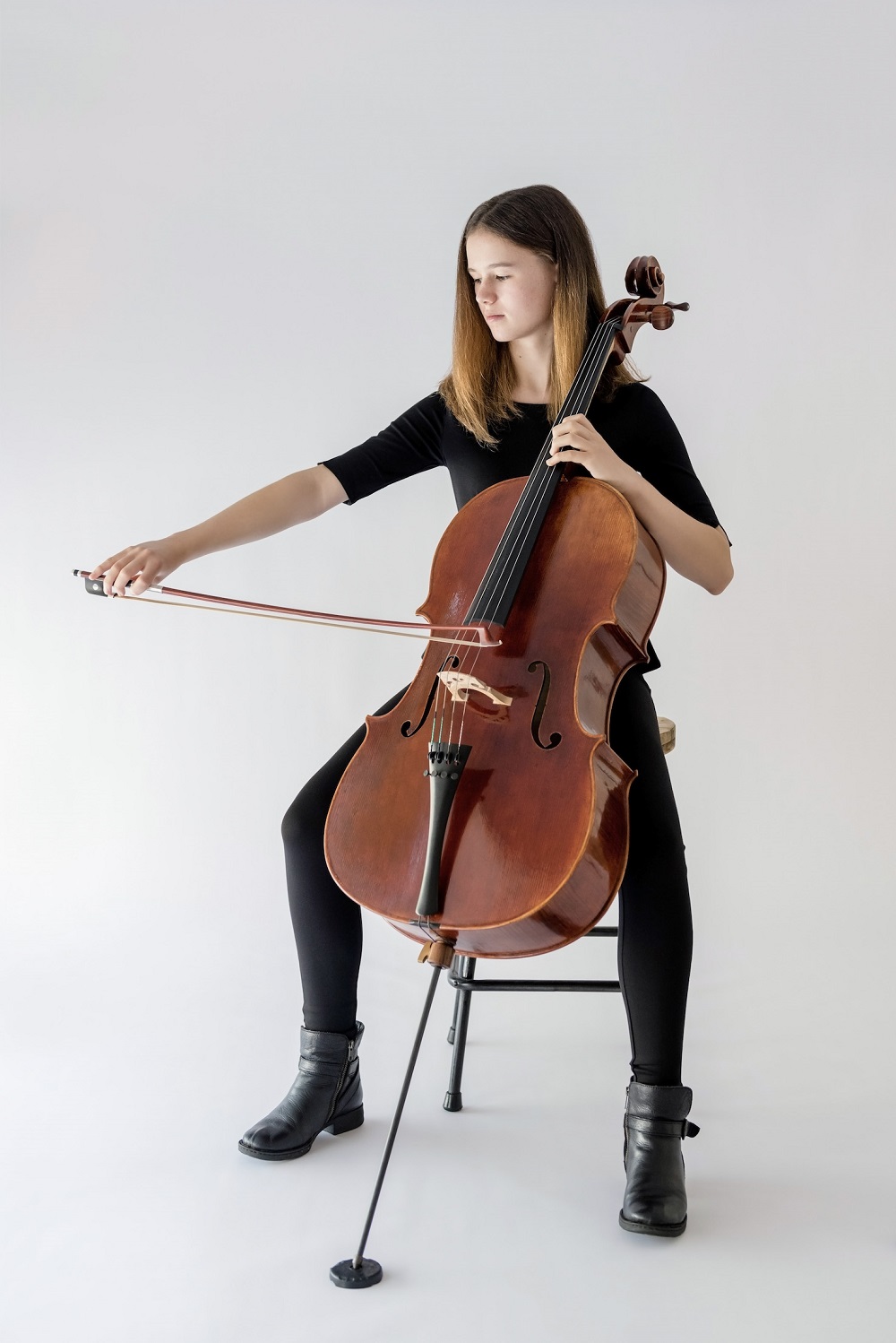 girl sitting playing cello