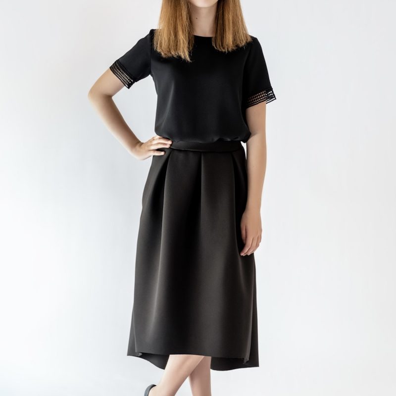 girl standing wearing black skirt and black blouse