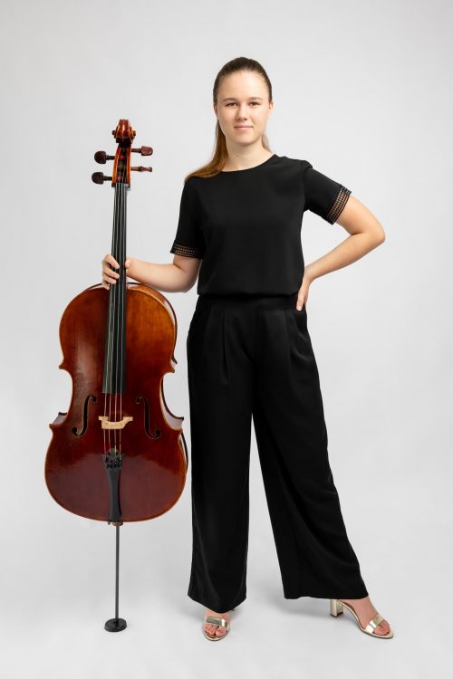 girl in black clothes holding cello